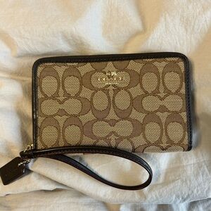 Never used Coach wristlet 
Full zip with interior card and bill slots